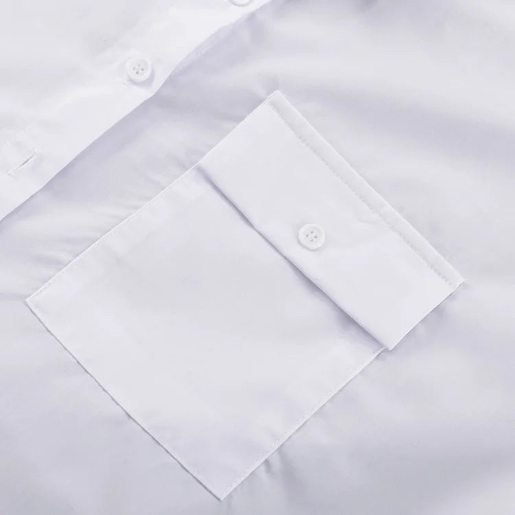 Close-up of a white dress shirt with button details on a light gray background