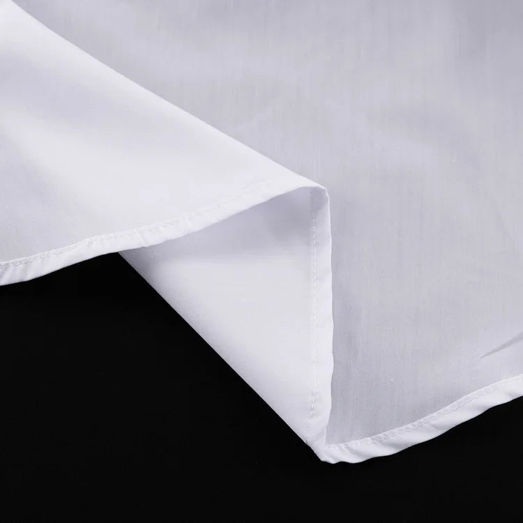 Close-up of a white fabric with a subtle pattern on a black background