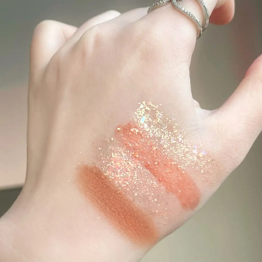 Makeup palette with various shades of eyeshadows and a brush on a white background Autumn Shades Trendy Waterproof