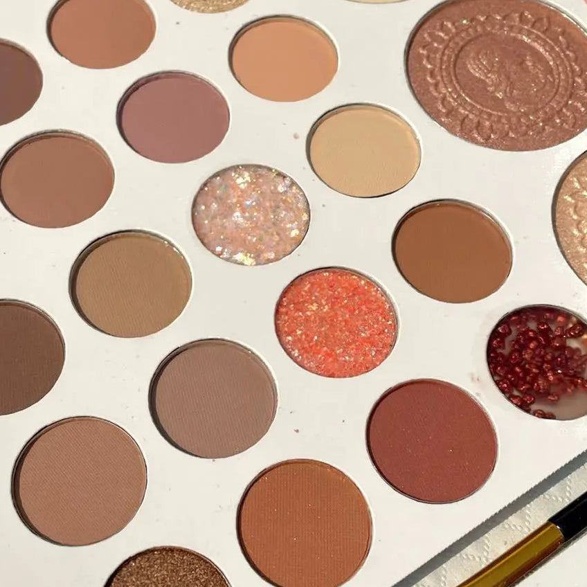 Makeup palette with various shades of eyeshadows and a brush on a white background Autumn Shades Trendy Waterproof