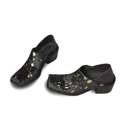 Pair of black shoes with gold speckles on a white background