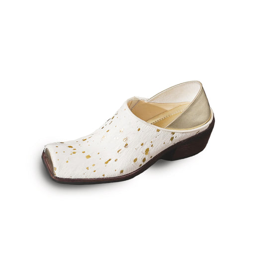 White shoe with gold speckles on a white background