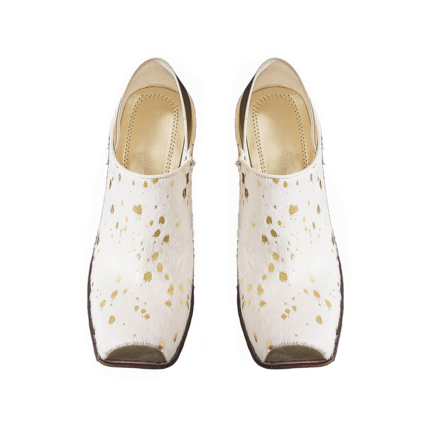 Pair of white shoes with gold speckles on a white background