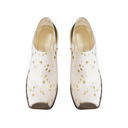 Pair of white shoes with gold speckles on a white background
