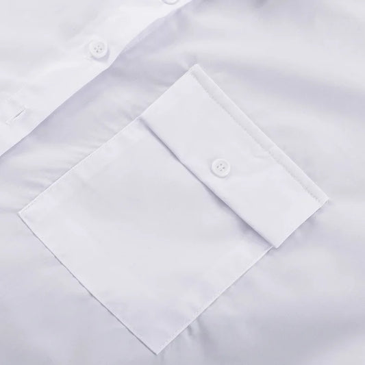 Close-up of a white dress shirt with button details on a light gray background