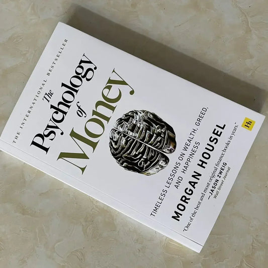 Book titled 'The Psychology of Money' on a textured surface